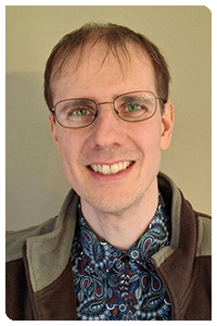 Foto einer der Organisatoren. Das Bild zeigt einen Mann mit Brille.